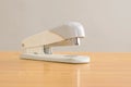 white stapler is on the table. Stationery