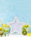 White star Photo frame mockup: cool and fresh kiwi watermelon lemonade with ingredients on blue background. Vegetarian food, heal