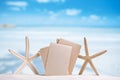 White starfish with blank retro photo on white sand beach, sky a Royalty Free Stock Photo