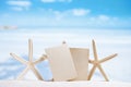 White starfish with blank retro photo on white sand beach, sky a Royalty Free Stock Photo