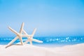 White starfish with ocean, on white sand beach, sky and seascape Royalty Free Stock Photo