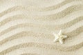 White starfish on sand texture background with wave pattern Royalty Free Stock Photo