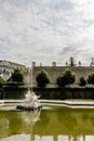 white statue of a boys with a mermaid at the fountain in the park