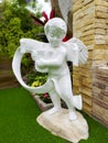 White statue of Cupid, the god of love. Royalty Free Stock Photo