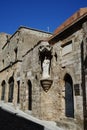 White statue of Our Lady and Child on the facade of a medieval building in the historic city of Rhodes, Greece
