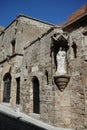 White statue of Our Lady and Child on the facade of a medieval building in the historic city of Rhodes, Greece