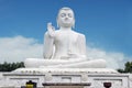 White statue of seated Buddha (Siddharta Gautama)