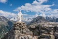 White statue of Virgin Mary, Mother of God, placed on top of the mountain. In the background there are snowy peaks. Royalty Free Stock Photo