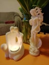 white statues with a candle light