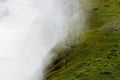 White steam and green hill covered with moss, Gulfoss waterfall, Iceland Royalty Free Stock Photo