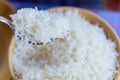 White steam rice on a spoon macro detail and background