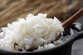 White steamed rice in black round pot