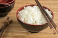 White steamed rice in a bowl with chopsticks