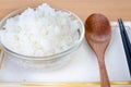 White steamed rice in bowl with chopsticks and wood spoon . Royalty Free Stock Photo