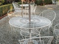 White steel garden cafe furniture on a gravel surface backyard