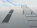 White steel ladder, on industrial wall background