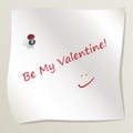 White sticky note attached to a wall by a drawing pin with heart image. Sheet of paper with text Be My Valentine with smile. Conce Royalty Free Stock Photo