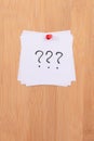 White Sticky Notes with Three Question Marks Pinned to the Wooden Message Board Royalty Free Stock Photo