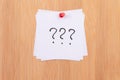 White Sticky Notes with Three Question Marks Pinned to the Wooden Message Board Royalty Free Stock Photo