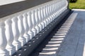 White stone balustrades along the marble tile walkway.