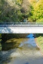 White stone bridge over a narrow river Royalty Free Stock Photo