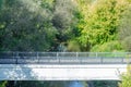 White stone bridge over a narrow river Royalty Free Stock Photo