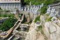 White stone carved statues of Chinese Buddha, priests and many animals on the artificial waterfall at Haedong Yonggungsa Temple