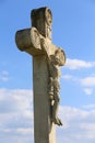 White stone cross against natural bue sky