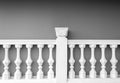 White stone fence balustrade opposite grey cement wall Royalty Free Stock Photo