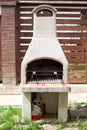 White stone garden stove for grill or barbecue is in backyard at summer season Royalty Free Stock Photo