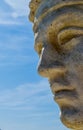 Grecian Statue face close up against blue sky