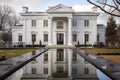 white stone greek revival mansion with mirrored entryways