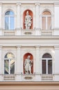 White stone or marble building with historic character or figure sculptures or statues. Arc windows, pillars and other amazing Royalty Free Stock Photo