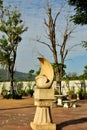 The White Stone Sculture in the garden with Dried Tree Royalty Free Stock Photo