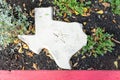 White stone shaped as state of Texas with a Lone Star symbol carved