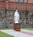 White stone statue of a woman near the Sacred Heart Cathedral in the Latvian city of Rezekne. July 2019