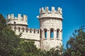 White stone turrets of a medieval castle against a blue sky background Royalty Free Stock Photo