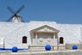 White stone wall with local symbolics in Campo de Criptana, Castilla la Mancha, Spain