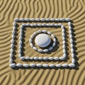 White stones are arranged in a geometric pattern on textured sand. A central circular formation Royalty Free Stock Photo