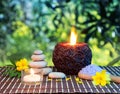 White stones and candles on bamboo mat - and yellow flowers Royalty Free Stock Photo