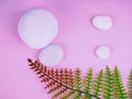 White stones on pink background, green leaves, top view, postcard for Your design Royalty Free Stock Photo