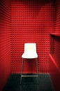 White stool in a red soundproof cabin