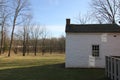 The white storage house on a bright sunny day.