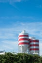 White storage tanks with red stripes