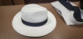 White straw Panama hat and plain shirt and black knit tie on menswear counter in store - Shopping for a man Royalty Free Stock Photo