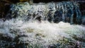 White stream water falling with white water bubbles