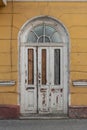 Old shabby front door to the building