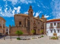 White street of Spanish town Carmona and statue of Santa Maria church