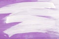 White strokes on violette wooden background.