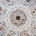 White stucco ceiling sculpted inside a votive chapel.